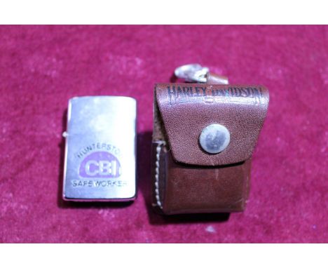 A brass Zippo lighter with leather pouch 