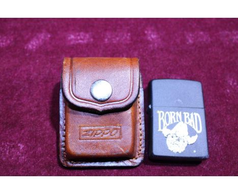 A brass Zippo lighter with leather pouch 
