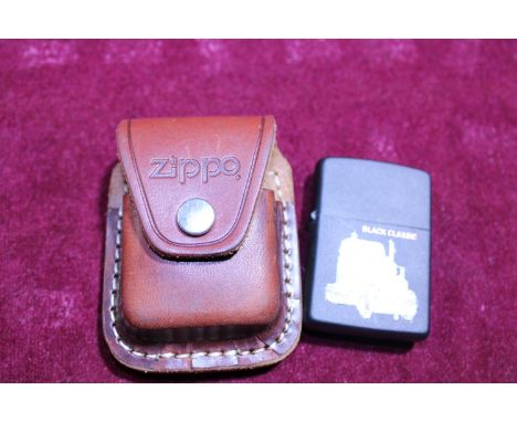 A brass Zippo lighter with leather pouch 