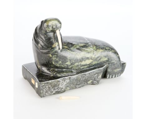 One large J. Tobuk carved stone walrus on a stone base. The walrus with incised details for the fins and face. Signed in Roma