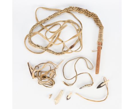 Group of Inuit tools including:One leather and wood sled dog whip from Taloyoak (Spence Bay).One bone and baleen spear point 