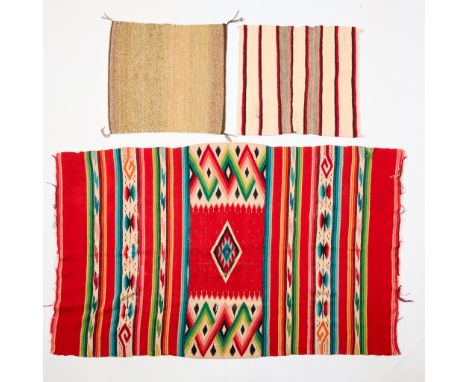 Group of three Dine Navajo Native American woven wool rugs, saddle blankets, or wall-hanging textiles. The largest possibly a