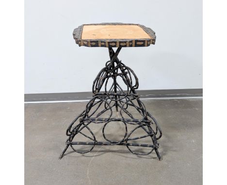 Adirondack table made from curled twigs and branches. Tabletop features fabric center covering and painted wood rim. Great as