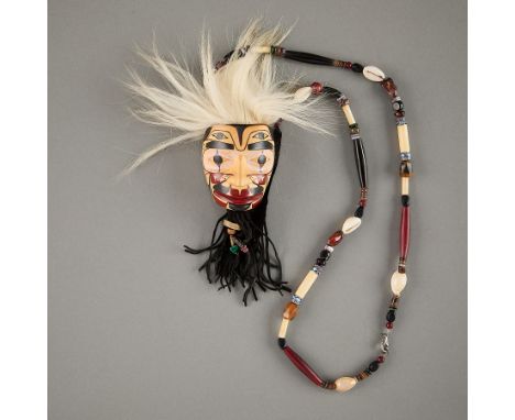 Robert Hewson (Tsimshian, b. 1946). Necklace comprised of central carved wood mask with leather backing and fringe on a neckl