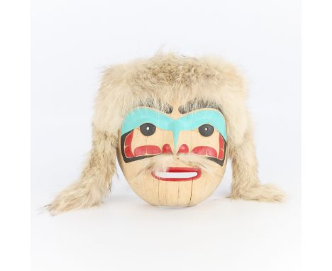 Tsoona Stella (Haida, 1937-2014). Carved wooden mask titled "Portrait Nax'Nok" depicting a solemn expression, 1990. With pain