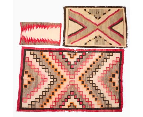 Group of three Dine Navajo Native American woven wool rugs, double saddle blankets, or wall-hanging textiles. Including South