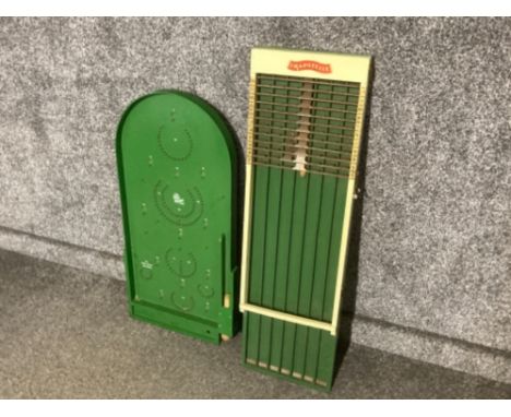 A bagatelle board together with a trapatelle board
