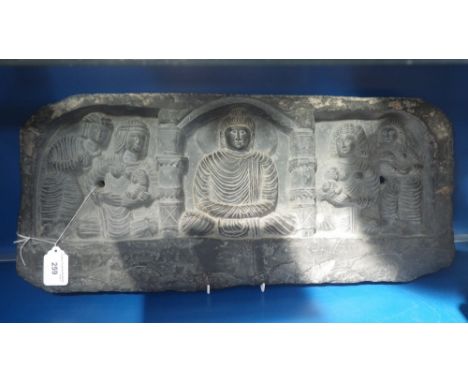 A 'Schist' stone carving with a seated Buddha beneath an arch, surrounded by mothers with their children, 26 cms x 56cms