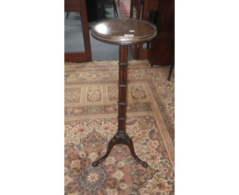 A reproduction mahogany Chippendale style torchère on tripod support with gallery top, 42" high