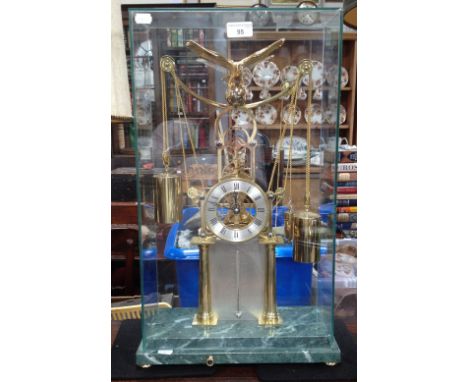 A contemporary skeleton clock with brass movement and four polished weights, with silvered chapter ring and thermometer fitte