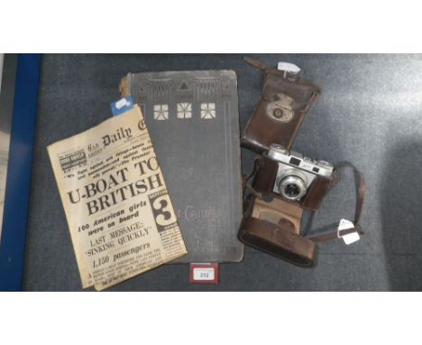 A collection of early 20th century and later postcards, a plate camera, an Iloca camera and a wartime newspaper (4)