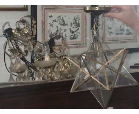 A star lantern and a gilt chandelier with droplets