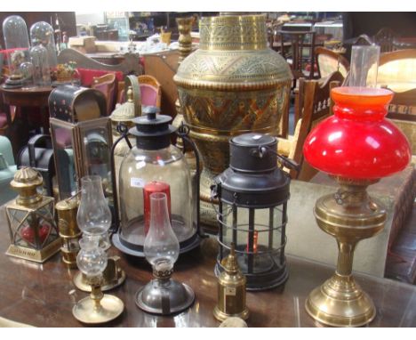 A circular metal garden lantern with glass storm shade, another similar and a collection of similar lamps and lighting