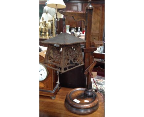 An Arts and Crafts style oak table lamp with adjustable mechanism and hanging shade