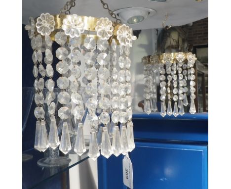 A pair of cut-glass chandeliers with glass flowerhead mounts and other similar light fittings, including wall-mounted 