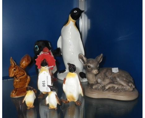 Four Beswick penguin ornaments, a Poole pottery penguin ornament and other items