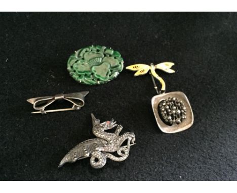 Four brooches including a 'jade' mounted brooch