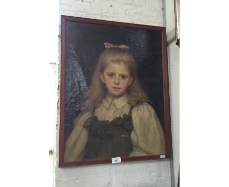 A late 19th/early 20th century portrait of a young girl, her hair tied in a yellow ribbon, oil on canvas