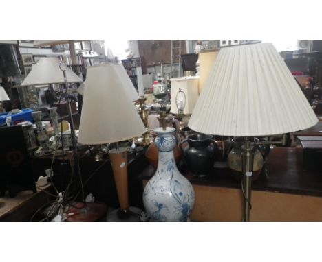 A hand painted blue and white ceramic table lamp, two contemporary table lamps and a standard lamp