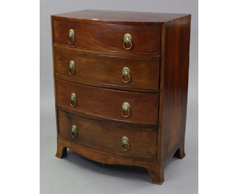 A regency-style mahogany small bow-front chest, fitted four long graduated drawers with brass lion-mask ring handles, &amp; o