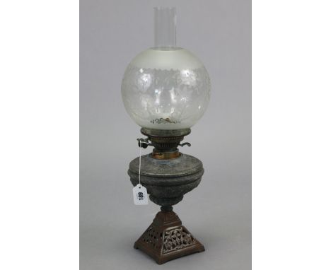 A cast-iron oil table lamp with etched-glass globular shade, 22” high; together with various decorative ornaments; three suit