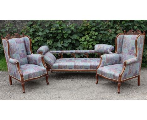 An Edwardian beech-frame three-seater settee with padded seat, back, &amp; scroll arms upholstered multi-coloured geometric m