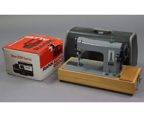 An Alfa standard electric sewing machine with case; a Sankyo movie camera; a ditto “Dualux 1000” projector; &amp; a Rand Aldi