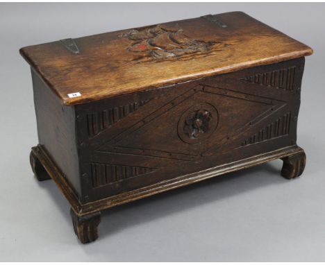 A small oak coffer with carved decoration to the hinged lift-lid &amp; front, &amp; on carved bracket feet, 32” wide x 19½” h