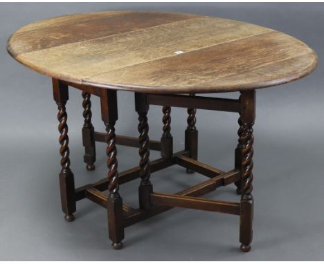 A 1930’s oak oval gate-leg dining table on barley-twist legs &amp; turned feet with plain stretchers, 42” x 52”; a pine side 