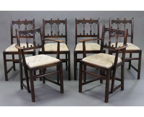 A set of six Ercol oak spindle-back dining chairs (including a pair of carvers) with padded drop-in-seats, &amp; on square ch