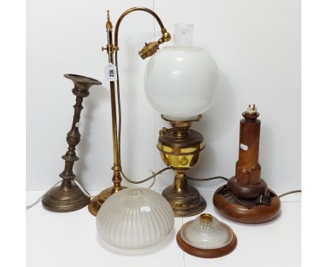 An Edwardian style brass desk lamp with scroll-arm, &amp; on circular base, 22” high; together with two table lamps; &amp; a 