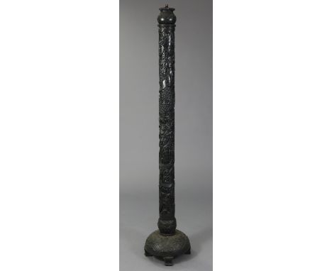 An early 20th century eastern carved &amp; pierced ebonised wooden torchere/standard lamp, the cylindrical column decorated w