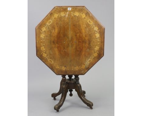 A late Victorian centre table with marquetry-inlaid foliate decoration to the octagonal tilt-top, &amp; on four turned suppor