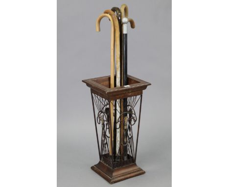 A mahogany-finish umbrella stand, 11½” wide x 22½” high; together with six walking canes; &amp; a clothes-rail.