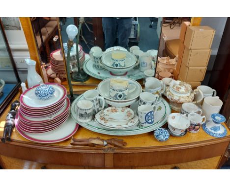 A flex-arm table lamp on cast-metal base; together with twelve various commemorative mugs; &amp; two ethnic carved wooden fig