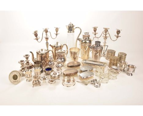 A collection of silver plated and white metal itemsTo include pierced white metal canisters, various condiments, a pair of pl