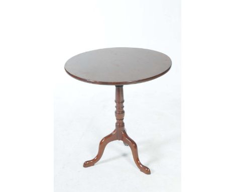 A George III mahogany tripod tableWith a circular top supported on a ring turned tapering shaft on three downswept supports w