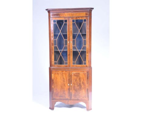 A 19th Century inlaid mahogany glazed freestanding corner cupboardWith a moulded dentil cornice above a crossbanded inlaid fr