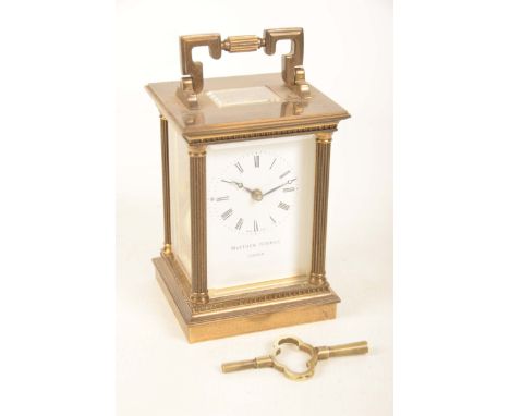 A brass cased carriage clock by Mathew Norman of LondonThe case with an angular swing handle and architectural reeded columns