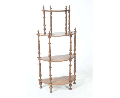 A Victorian walnut four tier whatnot Each half moon shaped shelf centered with an inlaid urn and scrolling vinery, the shelve