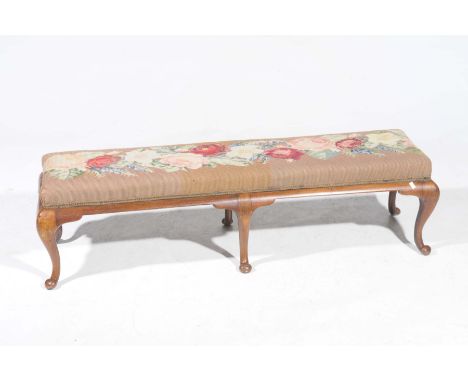 A 19th Century mahogany and upholstered long stoolWith a rectangular rose design tapestry seat, supported on a mahogany frame