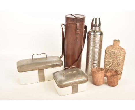 An early 20th Century Thermos flask and caseThe ribbed cylindrical Thermos flask with a fitted leather case, along with two c