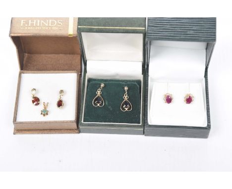 A pair of 9k gold and garnet ear dropsThe oval garnets suspended from ear posts and butterfly backs, together with a similar 