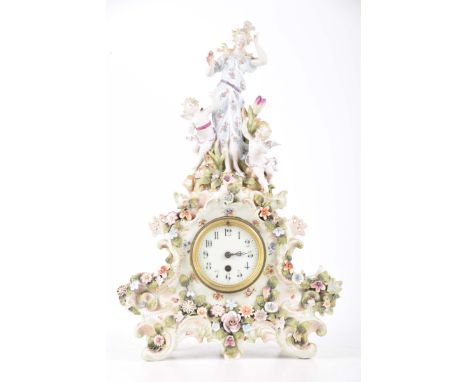 An early 20th Century continental figural ceramic mantel clockThe case mounted with a classical group, female figure making m