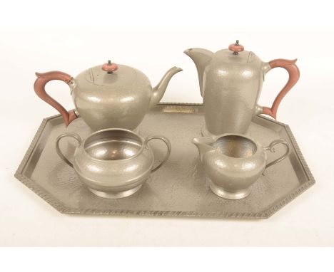An early 20th Century Manor Period hammered pewter five piece tea setThe tea and coffee pot with button finials and looped ha