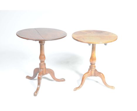 Two Georgian oak tripod tablesEach with a circular top supported on a baluster turned shaft with three downswept supports and