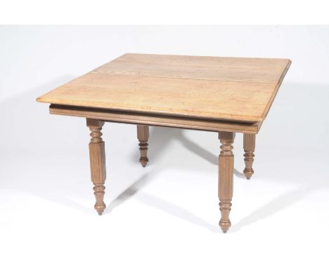 A rustic light oak kitchen table The rectangular moulded top raised on four legs of reeded square section, 120x73x110cm.