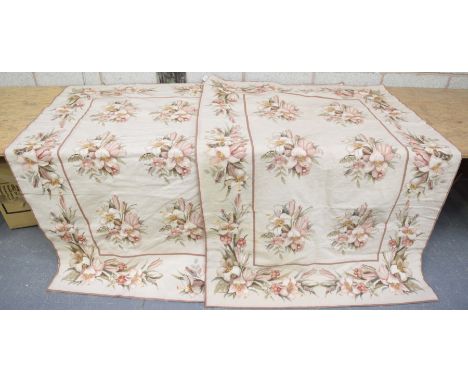 A near pair of tapestry wall hangingsEach with a floral border upon a beige ground.