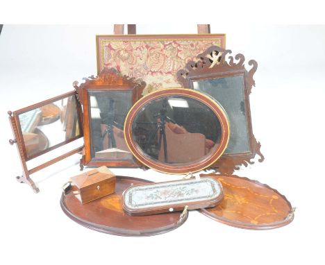 Two inlaid tea trays and various mirrorsTo include two Edwardian oval trays with brass handles, a crossbanded oval wall mirro