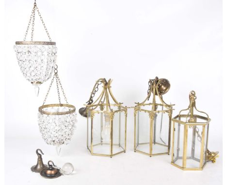 Three gilt metal and glazed hanging ceiling lanterns and two glass droplet light fittingsThe lanterns of typical form with si